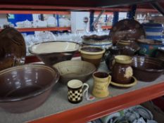 A GROUP OF STONEWARE SLIP GLAZE PIECES to include a German wall hanging charger with the humourous