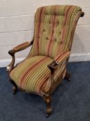 A 19TH CENTURY WALNUT EASY CHAIR, with striped upholstery, scrolled open armrests, rasied on front