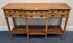 A REPRODUCTION YEW WOOD BREAK FRONT SIDE TABLE, fitted with nine small drawers, raised on square