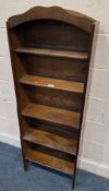 AN EARLY 20TH CENTURY OAK WATERFALL OPEN BOOKCASE, with an arched top and five shelves Dimensions: