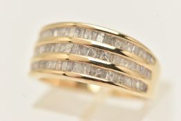 A 9CT YELLOW GOLD DIAMOND BAND RING, a tripple row of channel set baguette cut diamonds, approximate