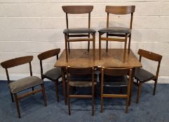 A MID-CENTURY TEAK EXTENDING DINING TABLE, with one additional leaf, raised on tapered legs, along