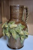 A RYE POTTERY HOP JUG, comprising an early 20th Century Rye Sussex Rustic ware Art pottery jug,