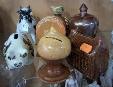 A GROUP OF MONEY BOXES AND A COW FIGURE, comprising an unmarked raku fired studio pottery figure