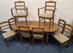 A MODERN PINE OVAL EXTENDING DINING TABLE, with a single fold-out leaf, raised on turned legs, along