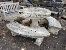 A WEATHERED CONCRETE CIRCULAR GARDEN TABLE, on a scrolled-shaped base, diameter 115cm x height 80cm,