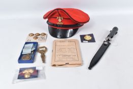 A BOX OF ASSORTED MILITARY RELATED ITEMS, to include a UN medal for Korea, a 9th/12th Lancers peaked