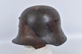 A WWI-ERA GERMAN M17 HELMET WITH CAMOUFLAGE PAINT, the liner inside the helmet over time has worn,