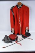 A COLDSTREAM GUARDS NUMBER ONE DRESS UNIFORM with two peaked caps, gloves, riding crop and a WWII