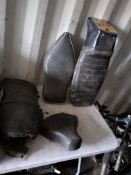 FOUR VINTAGE BRITISH MOTORCYCLE SADDLES AND PILLION SEATS, including a possible AJS seat in good