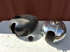 TWO VINTAGE BRITISH MOTORCYCLE PETROL TANKS comprising a black AJS/Matchless with cap and a BSA (