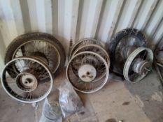 A COLLECTION OF VINTAGE SPOKED MOTORCYCLE WHEELS along with various tyres, including two still