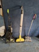 A G TECH AIR RAM UPRIGHT VACUUM CLEANER with charger and a bag containing accessories, a Shark