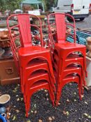 A SET OF EIGHT PRESSED STEEL STACKING CHAIRS with hooped backs and solid splats
