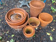 ELEVEN TERRACOTTA PLANT POTS AND PLATTERS, including one at 32cm in diameter Condition Report:most