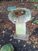 A MID 20TH CENTURY RECONSTITUETD CAST STONE BIRDBATH with a square footing, a tapered column and