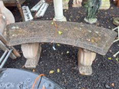 A CURVED CONCRETE GARDEN BENCH with foliate bosses to both supports, 122cm wide