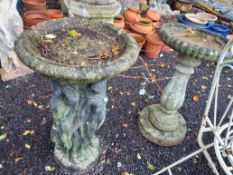 TWO CONCRETE BIDBATHS, one with a figural base, 77cm high, the other with a balustered base, both