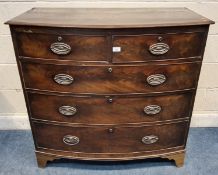 A GEORGIAN MAHOGANY BOW FRONT CHEST OF TWO SHORT OVER THREE LONG GRADUATED DRAWERS, raised on