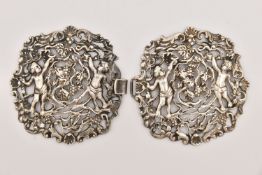 A WHITE METAL NURSES BELT BUCKLE, of an open work design, depicting cherubs, grape vines and shells,