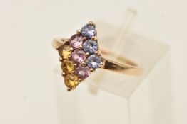 A YELLOW METAL GEM SET CLUSTER RING, circular cut pink, blue and yellow sapphires, nine stones in