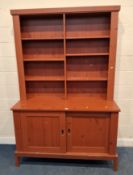 A MODERN RED PAINTED PINE EFFECT DRESSER, with six assorted shelves atop a base with double