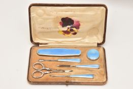 A CASED SILVER AND BLUE ENAMEL MANICURE SET, comprising of a nail buffer, cuticle tool, nail file,