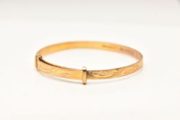 A 9CT GOLD CHRISTENING BANGLE, foliate pattern, personal engraving reads 'Sharon Elizabeth Daniel