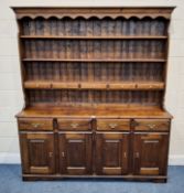 A MODERN PINE DRESSER, the four-tier plate rack with five drawers, atop a base with four drawers