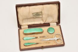 A CASED SILVER GILT AND GREEN ENAMEL ART DECO MANICURE SET, comprising of a nail buffer, cuticle