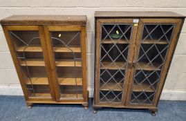 TWO 20TH CENTURY OAK BOOKCASES, both with double lead-glazed doors, raised on cabriole legs