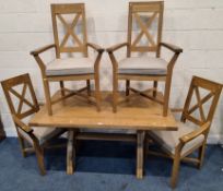 A MODERN SOLID OAK RECTANGULAR DINING TABLE, raised on cross frame legs, united by a stretcher,