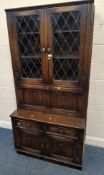 A LATE 20TH CENTURY OAK CABINET, with double lead-glazed doors, a fall front door, two drawers and