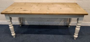 A PARTIALLY PAINTED PINE FARMHOUSE STYLE TABLE, raised on block and turned legs Dimensions:width