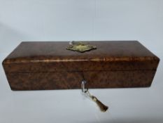 A 19TH CENTURY THUYA WOOD GLOVE BOX, the cover bearing a gilt metal vacant cartouche, with