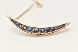 A 9CT YELLOW EARLY 20TH CENTURY BROOCH, a crecent brooch set with twelve circular cut blue paste