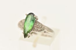 AN 18CT WHITE GOLD GEM SET RING, an elongated pear cut green tourmaline, flanked with single cut
