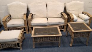 A RATTAN SIX PIECE CONSERVATORY SUITE, comprising a two-seater sofa, a pair of armchairs, a