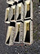 SEVEN COTSWOLD STONE OBLONG CONCRETE PLANTERS with rose bosses to front and back, 61cm long