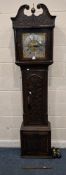 AN OAK CASED LONGCASE CLOCK, with geometric and foliate carved details all over, the twin swan