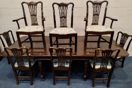 A MAHOGANY EXTENDED DINING TABLE, with three additional leaves, raised on cylindrical tapered legs