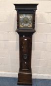 AN OAK CASED 30 HOUR LONGCASE CLOCK, the glass door enclosing a ten-inch brass and silvered dial,