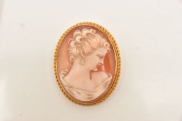 A 9CT GOLD CAMEO BROOCH, of an oval form, carved shell cameo depicting a lady in profile, collet set
