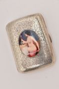 A SILVER AND ENAMEL CIGARETTE CASE, rectangular form with ivy decoration, set to the centre with