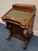 A REPRODUCTION DAVENPORT, with a small lidded compartment, the hinged writing surface enclosing a