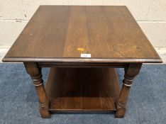 AN OAK OCCASIONAL TABLE, raised on block and turned legs, united by an undershelf Dimensions:61cm