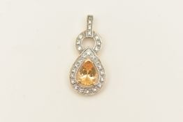 A 9CT GOLD GEM SET PENDANT, a pear cut imperial topaz set with a surround of circular cut colourless