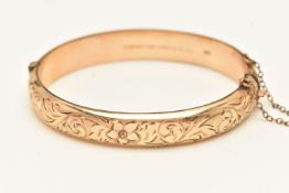 A ROLLED GOLD HINGED BANGLE, foliate pattern, fitted with a push button clasp and additional