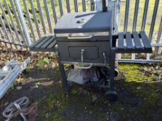 A CHARCOAL BARBECUE with lid, a height-adjustable rack, folding side wings and covert Condition
