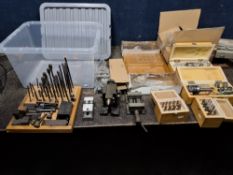 A TRAY CONTAINING MILLING MACHINE TOOLS AND ACCESSORIES, including one new and a used set of hold-